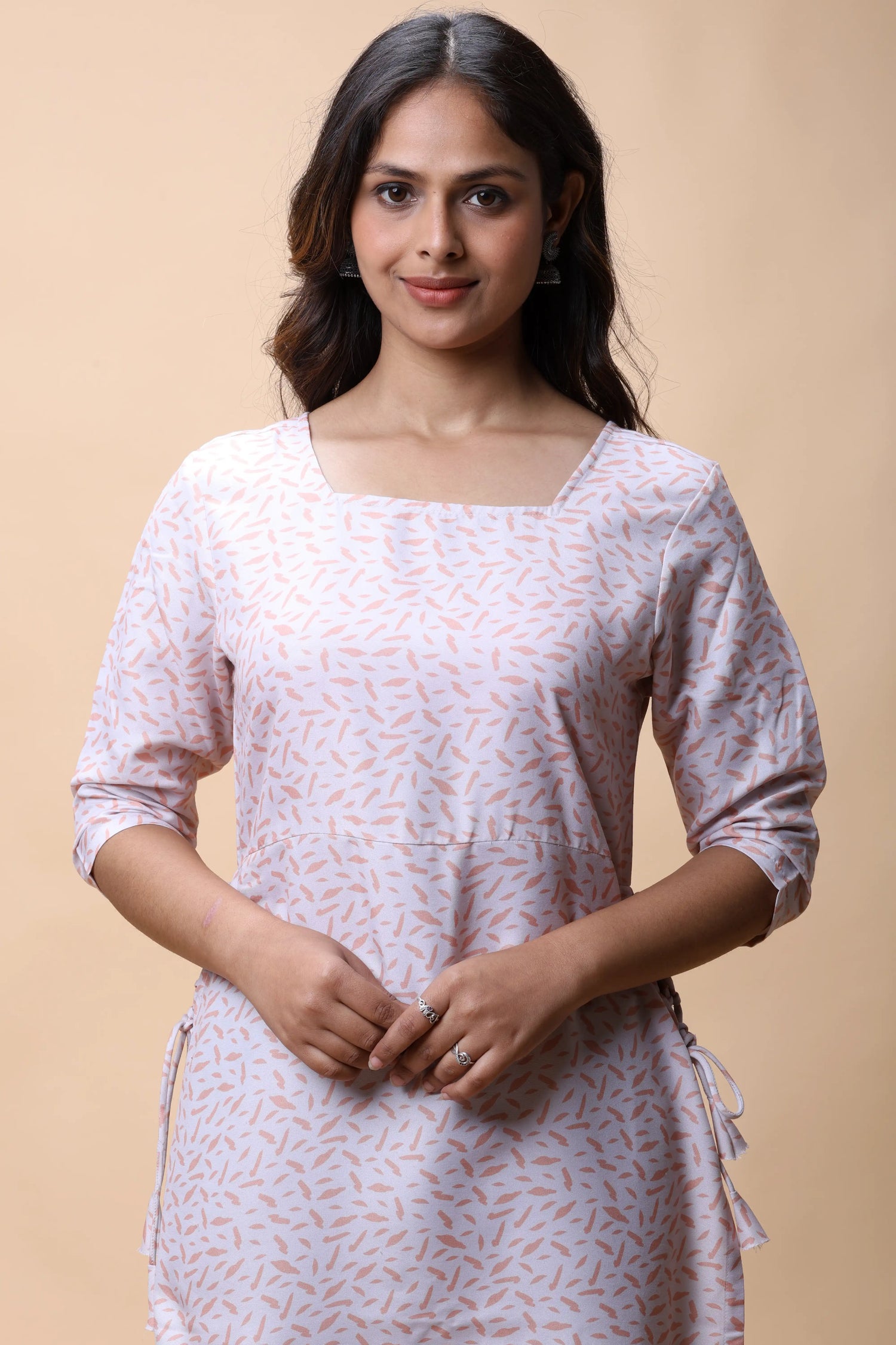 Woman wearing chocolate brown long kurti with white pants - allthere.in